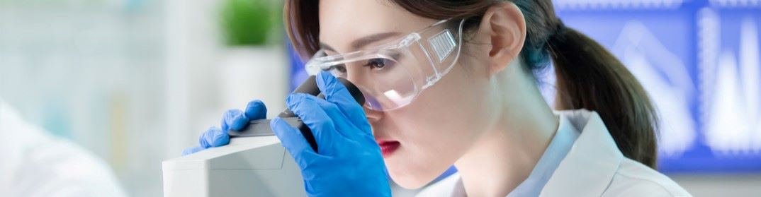 Scientist looking into a microscope