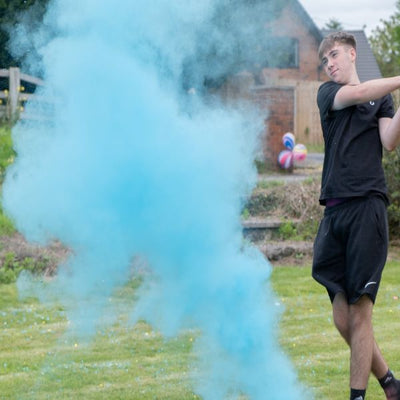 plume of blue powder and a young man