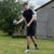 young man getting ready to kick a football he is holding in his hand