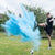 young man kicked a football which exploded releasing blue powder