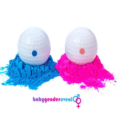 Two gold balls on top of pink and blue powder